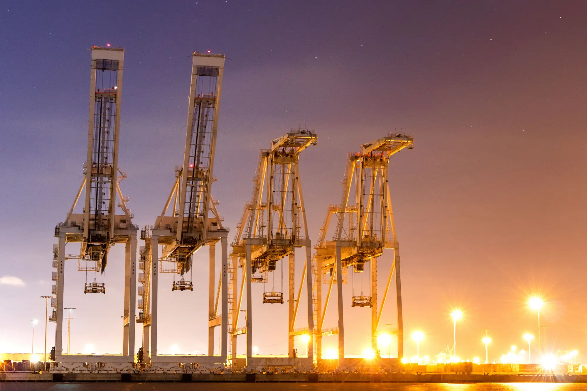 Container cranes at a port terminal at night